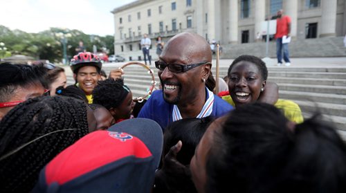 TREVOR HAGAN / WINNIPEG FREE PRESS
Ken Opaleke, executive director of the West Broadway Youth Outreach organization is mobbed after he, and 11 others received the Order of Manitoba during a ceremony at the Legislative Building, Thursday, July 12, 2018.