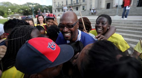 TREVOR HAGAN / WINNIPEG FREE PRESS
Ken Opaleke, executive director of the West Broadway Youth Outreach organization is mobbed after he, and 11 others received the Order of Manitoba during a ceremony at the Legislative Building, Thursday, July 12, 2018.