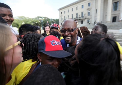 TREVOR HAGAN / WINNIPEG FREE PRESS
Ken Opaleke, executive director of the West Broadway Youth Outreach organization is mobbed after he, and 11 others received the Order of Manitoba during a ceremony at the Legislative Building, Thursday, July 12, 2018.