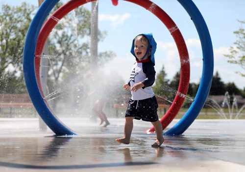 RUTH BONNEVILLE / WINNIPEG FREE PRESS

Caleb Brown (21months) cools himself  while playing in the water with his older brother Benjamin (not in photo) at The Gateway Recreation Centre spray pad in the scorching heat Friday.  
Standup photo 


July 13, 2018 

