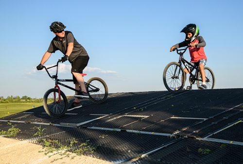 Mike Sudoma / Winnipeg Free Press
"Roger Rogersson (left) a rider of over 40 years of experience shows first time rider, Ray Ray Ducharme (Right) how to ride the race course at Destination X BMX Park" July 13, 2018