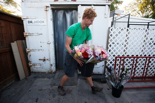 JOHN WOODS / WINNIPEG FREE PRESS
Colin Rémillard, co-owner of St-Léon Garden, moves some flowers so he can get at the fruit and vegetables in a refrigerator in Winnipeg Friday, July 13, 2018. This is part of the 24hourproject

