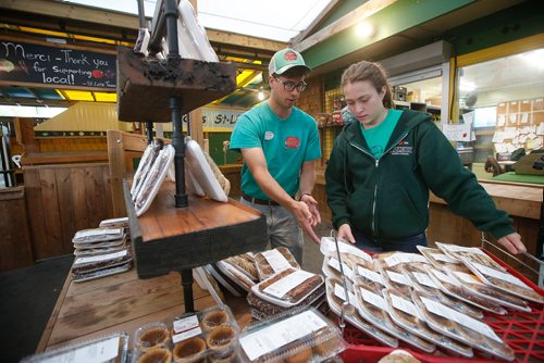 JOHN WOODS / WINNIPEG FREE PRESS
Blake Hunnie and Megan Kinsman set up the baking shelves before the store opens at St-Léon Garden in Winnipeg Friday, July 13, 2018. This is part of the 24hourproject

