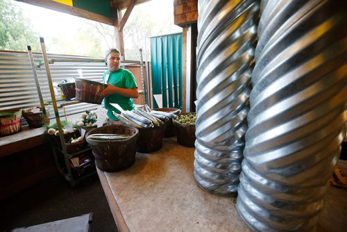 JOHN WOODS / WINNIPEG FREE PRESS
Julian Parent sets up the veggie shelves before the store opens at St-Léon Garden in Winnipeg Friday, July 13, 2018. This is part of the 24hourproject
