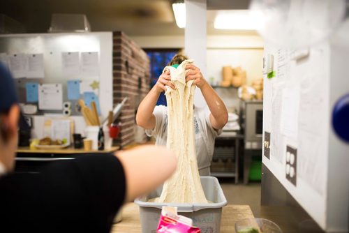 MIKAELA MACKENZIE / WINNIPEG FREE PRESS
Owner Suzanne Gessler turns the bread dough at Pennyloaf bakery in Winnipeg on Friday, July 13, 2018. 24hourproject
Mikaela MacKenzie / Winnipeg Free Press 2018.