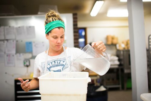 MIKAELA MACKENZIE / WINNIPEG FREE PRESS
Owner Suzanne Gessler feeds the sourdough starter with flour and water at Pennyloaf bakery in Winnipeg on Friday, July 13, 2018. 24hourproject
Mikaela MacKenzie / Winnipeg Free Press 2018.