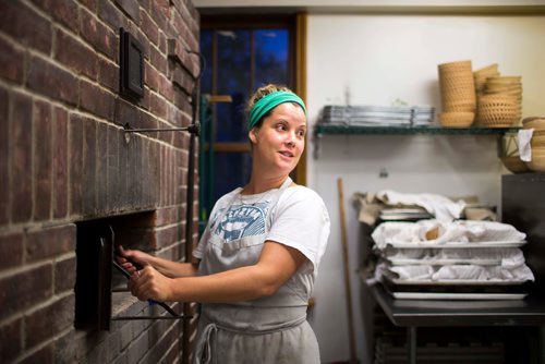 MIKAELA MACKENZIE / WINNIPEG FREE PRESS
Owner Suzanne Gessler lights the oven at Pennyloaf bakery in Winnipeg on Friday, July 13, 2018. 24hourproject
Mikaela MacKenzie / Winnipeg Free Press 2018.