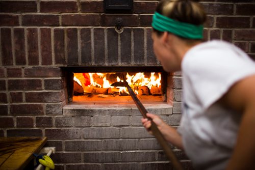 MIKAELA MACKENZIE / WINNIPEG FREE PRESS
Owner Suzanne Gessler lights the oven at Pennyloaf bakery in Winnipeg on Friday, July 13, 2018. 24hourproject
Mikaela MacKenzie / Winnipeg Free Press 2018.