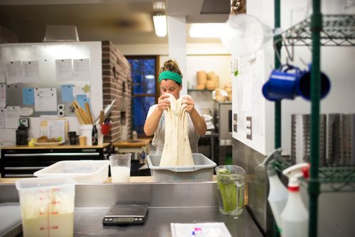 MIKAELA MACKENZIE / WINNIPEG FREE PRESS
Owner Suzanne Gessler turns the bread dough at Pennyloaf bakery in Winnipeg on Friday, July 13, 2018. 24hourproject
Mikaela MacKenzie / Winnipeg Free Press 2018.