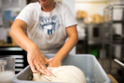 MIKAELA MACKENZIE / WINNIPEG FREE PRESS
Owner Suzanne Gessler turns the bread dough at Pennyloaf bakery in Winnipeg on Friday, July 13, 2018. 24hourproject
Mikaela MacKenzie / Winnipeg Free Press 2018.