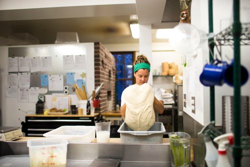 MIKAELA MACKENZIE / WINNIPEG FREE PRESS
Owner Suzanne Gessler turns the bread dough at Pennyloaf bakery in Winnipeg on Friday, July 13, 2018. 24hourproject
Mikaela MacKenzie / Winnipeg Free Press 2018.