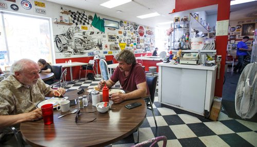 MIKE DEAL / WINNIPEG FREE PRESS
Owner Rick Wareham (right) prepares an order while regulars get into their breakfast shortly after opening at 8 am.
The early morning breakfast crowd at Big Ricks Hot Rod Diner, 379 Henderson.
180713 - Friday, July 13, 2018.
24hourproject