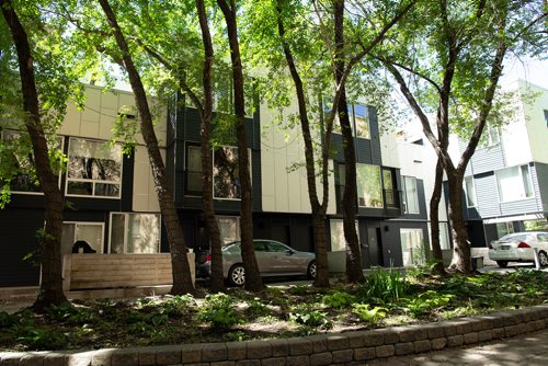 ANDREW RYAN / WINNIPEG FREE PRESS  The secluded entrance to unit 4 of 443 Webb place is located in an alley off of Webb behind a small grouping of trees. The unit is a one bedroom loft style home. Shot on July 17, 2018.