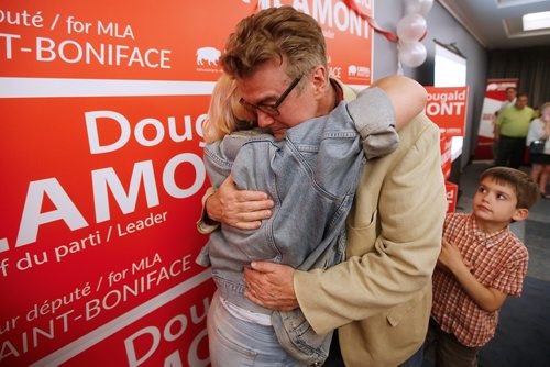 JOHN WOODS / WINNIPEG FREE PRESS
Dougald Lamont, leader of the Manitoba Liberal Party, hugs his daughter as his son Rufus looks as they celebrate a win in the St. Boniface by-election in Winnipeg Tuesday, July 17, 2018.