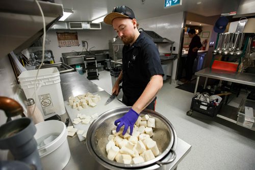 MIKE DEAL / WINNIPEG FREE PRESS
The Merchant Kitchen restaurant at 314 Donald Street.
Catering chef Dashiell Pool prepares yucca root in the kitchen.
The kitchen prepares food from their updated menu for a social media promotion including a sneak peak of their burger week creation which will debut at the beginning of September.
180713 - Friday, July 13, 2018.
24hourproject