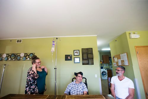 MIKAELA MACKENZIE / WINNIPEG FREE PRESS
Benjamin Brubacher, 31, gets tube fed with support worker Samantha Franklin (left) and his dad Mark Brubacher in a St. Amant group home in Winnipeg on Friday, July 13, 2018. 24hourproject
Mikaela MacKenzie / Winnipeg Free Press 2018.