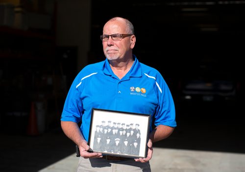 ANDREW RYAN / WINNIPEG FREE PRESS  Bruce Henley, holds a photograph of his late father, Bob Henley, during his time as a firefighter on July 18, 2018.