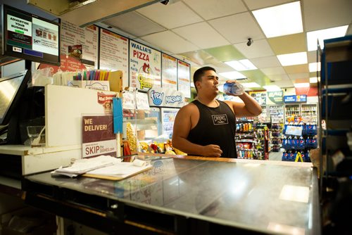 ANDREW RYAN / WINNIPEG FREE PRESS  Francisco Flett takes a gulp of water while waiting for an order of egg rolls to be made at Walia's Gas & Carwash at around 4:00 a.m. on Friday July 13, 2018. 24hourproject