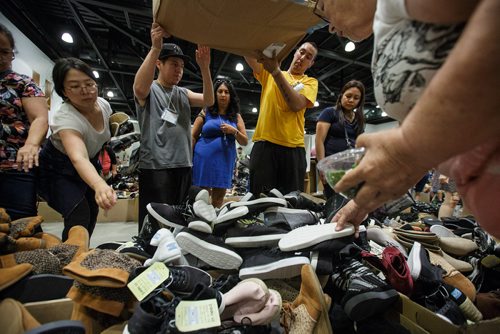MIKE DEAL / WINNIPEG FREE PRESS
TOMS is having a warehouse sale from July 19-22 at the RBC Convention Centre. They expect about 7,000 customers on the first day and over 25,000 shoes will be available.
Customers can bareley wait for the shoes to be dumped straight from a box before reaching in for a pair.
180719 - Thursday, July 19, 2018.