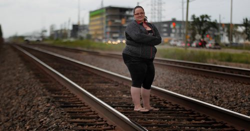 PHIL HOSSACK / WINNIPEG FREE PRESS - Kari Olson poses on the CNR main line near Shaftsbury where she maintains trains started fires this spring. See Ryan's story.  - July 17, 2018