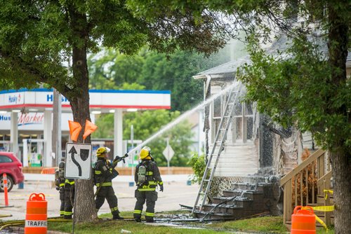 MIKAELA MACKENZIE / WINNIPEG FREE PRESS
Firefighters put out lingering hot spots at a house fire at Arlington and Ellice in Winnipeg on Friday, July 20, 2018. 
Mikaela MacKenzie / Winnipeg Free Press 2018.