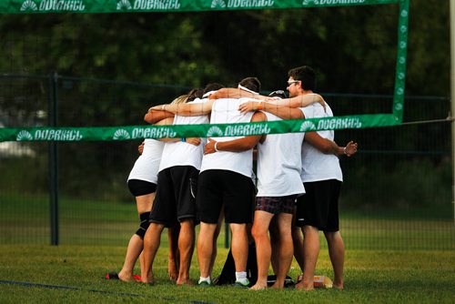 PHIL HOSSACK / WINNIPEG FREE PRESS - SUPERSPIKE - Participants in the annual beach volleyball tournament huddle before their match Friday night at Maple Grove Park. See story.  - July 20, 2018