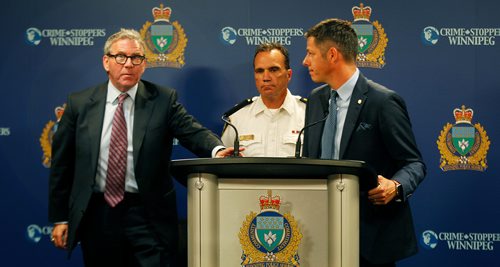 PHIL HOSSACK / WINNIPEG FREE PRESS - Police Board Chair David Asper (left) rises to address a press conference flanked by Police Chief Danny Smyth (centre) and Mayor Brian Bowman at the Monday morning press briefing. See story.   - July 23, 2018