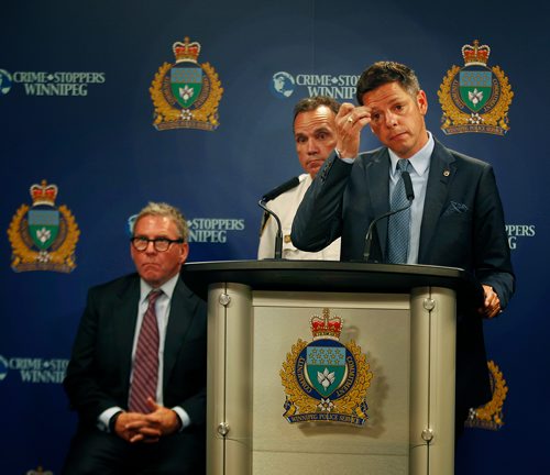 PHIL HOSSACK / WINNIPEG FREE PRESS - Police Board Chair David Asper (sitting)  Police Chief Danny Smyth (centre) and Mayor Brian Bowman at the Monday morning press briefing. See story.   - July 23, 2018