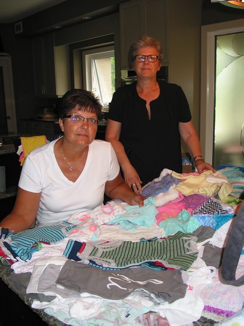 Canstar Community News July 16, 2018 - (From left) Sherry Desilets, of Headingley, and Maureen McCaughan, a former St. Francois Xavier resident, are shown with donations of baby items to the pair's Nighty Noodles campaign that they founded in memory of their friend Paulette McCaughan. (ANDREA GEARY/CANSTAR COMMUNITY NEWS)