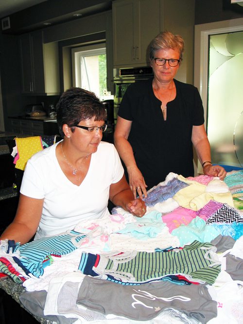 Canstar Community News July 16, 2018 - (From left) Sherry Desilets, of Headingley, and Maureen McCaughan, a former St. Francois Xavier resident, are shown with donations of baby items to the pair's Nighty Noodles campaign that they founded in memory of their friend Paulette McCaughan. (ANDREA GEARY/CANSTAR COMMUNITY NEWS)