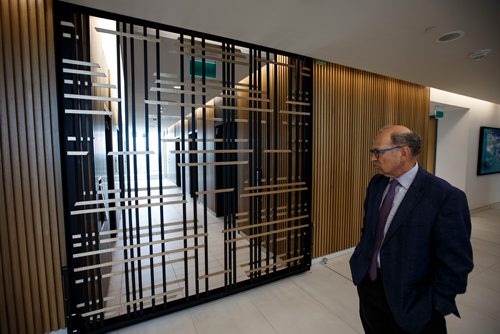 MIKE DEAL / WINNIPEG FREE PRESS
Partner Allan Finebleit looks at the locally made gate that will be used to close off the office from the elevators in the 17th floor offices of Thompson Dorfman Sweatman (TDS) at True North Square Monday morning. The gate was made by local blacksmith Cloverdale Forge.
180723 - Monday, July 23, 2018.