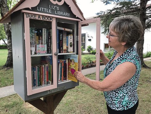 Canstar Community News Liz Martin said she hopes her new Little Free Library at 91 George Suttie Bay will be well used by the community in East Elmwood. (SHELDON BIRNIE/CANSTAR/THE HERALD)