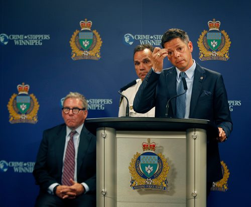 PHIL HOSSACK / WINNIPEG FREE PRESS - Police Board Chair David Asper (sitting)  Police Chief Danny Smyth (centre) and Mayor Brian Bowman at the Monday morning press briefing. See story.   - July 23, 201