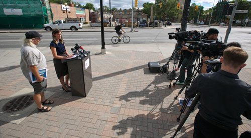 MIKE DEAL / WINNIPEG FREE PRESS
Liz Kulyk with CAA Manitoba and Mark Cohoe with Bike Winnipeg talk to the media at the corner of Osborne and Stradbrook during an effort to raise awareness and help frame the discussion about infrastructure and cycling ahead of the civic election.
180724 - Tuesday, July 24, 2018.