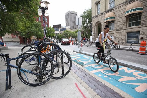 MIKE DEAL / WINNIPEG FREE PRESS
Cyclists in the Exchange District Tuesday morning. 
180724 - Tuesday, July 24, 2018.