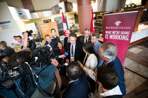 MIKAELA MACKENZIE / WINNIPEG FREE PRESS
Red River College president Paul Vogt scrums with the media after making a culinary research funding announcement at Red River College in Winnipeg on Wednesday, July 25, 2018. 
Winnipeg Free Press 2018.