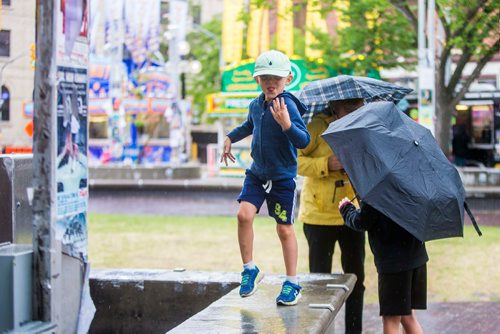 MIKAELA MACKENZIE / WINNIPEG FREE PRESS
Caleb Thiem dances in the rain at Old Market Square at the Fringe Festival in Winnipeg on Wednesday, July 25, 2018. 
Winnipeg Free Press 2018.