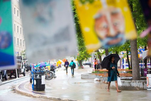 MIKAELA MACKENZIE / WINNIPEG FREE PRESS
Emmanuella walks past Old Market Square on a rainy day at the Fringe Festival in Winnipeg on Wednesday, July 25, 2018. 
Winnipeg Free Press 2018.