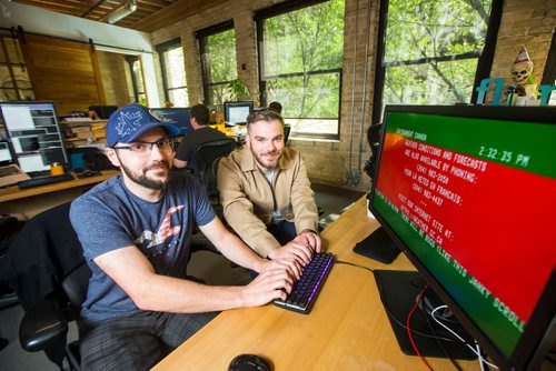 MIKAELA MACKENZIE / WINNIPEG FREE PRESS
Brandon Martel (left) and Craig Midwinter, who have resurrected the old-school Environment Canada weather channel, pose in their office in Winnipeg on Thursday, July 26, 2018. 
Winnipeg Free Press 2018.