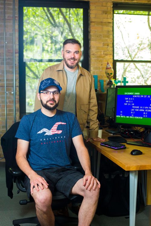 MIKAELA MACKENZIE / WINNIPEG FREE PRESS
Brandon Martel (left) and Craig Midwinter, who have resurrected the old-school Environment Canada weather channel, pose in their office in Winnipeg on Thursday, July 26, 2018. 
Winnipeg Free Press 2018.