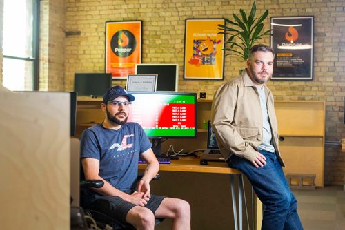 MIKAELA MACKENZIE / WINNIPEG FREE PRESS
Brandon Martel (left) and Craig Midwinter, who have resurrected the old-school Environment Canada weather channel, pose in their office in Winnipeg on Thursday, July 26, 2018. 
Winnipeg Free Press 2018.