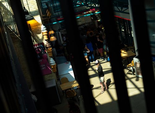 ANDREW RYAN / WINNIPEG FREE PRES A girls eats her ice cream after receiving it from the Neon Cone at The Forks Atrium on July 26, 2018.