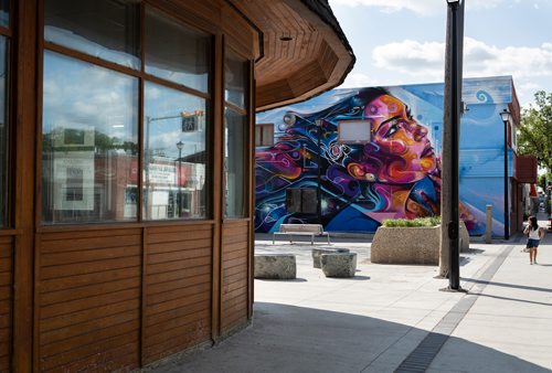 ANDREW RYAN / WINNIPEG FREE PRES A young girl walks past the recently unveiled mural painted onto the side of The Ndinawe Youth Resource Centre by UK based artist Mr Cenz on July 26, 2018. The mural was commissioned by  the Graffiti Gallery and was gifted to the centre in honour of the community of families and survivors of Missing and Murdered Indigenous Women and Girls and to Ndinawemaaganag Endaawaad Inc. as a thank you for the work that they do in relation to the cause.