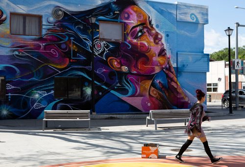 ANDREW RYAN / WINNIPEG FREE PRES A woman walks past the recently unveiled mural painted onto the side of The Ndinawe Youth Resource Centre by UK based artists Mr Cenz on July 26, 2018. The mural was commissioned by  the Graffiti Gallery and was gifted to the centre in honour of the community of families and survivors of Missing and Murdered Indigenous Women and Girls and to Ndinawemaaganag Endaawaad Inc. as a thank you for the work that they do in relation to the cause.