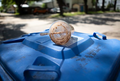 ANDREW RYAN / WINNIPEG FREE PRES Although made plastic, this drink cup can't be recycled because of the food residue left inside. Reporter Jill Wilson looked through Wolseley residents' recycling bins for misplaced items on July 26, 2018.