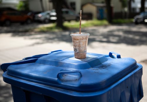 ANDREW RYAN / WINNIPEG FREE PRES Although made plastic, this drink cup can't be recycled because of the food residue left inside. Reporter Jill Wilson looked through Wolseley residents' recycling bins for misplaced items on July 26, 2018.
