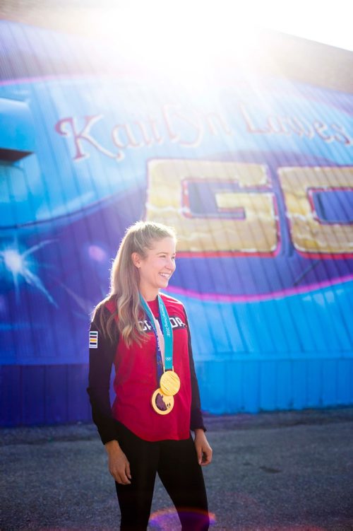 MIKAELA MACKENZIE / WINNIPEG FREE PRESS
Kaitlyn Lawes poses in front of St.Vital Curling Club's newest mural, commemorating her gold medal win in mixed doubles, in Winnipeg on Friday, July 27, 2018. 
Winnipeg Free Press 2018.