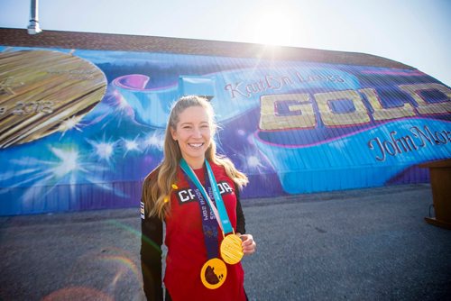 MIKAELA MACKENZIE / WINNIPEG FREE PRESS
Kaitlyn Lawes poses in front of St.Vital Curling Club's newest mural, commemorating her gold medal win in mixed doubles, in Winnipeg on Friday, July 27, 2018. 
Winnipeg Free Press 2018.