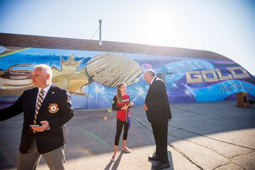 MIKAELA MACKENZIE / WINNIPEG FREE PRESS
Kaitlyn Lawes chats withTake Pride Winnipeg executive director Tom Ethans as St. Vital Curling Club president Ken Stevens walks out of frame in front of St.Vital Curling Club's newest mural, commemorating her gold medal win in mixed doubles, in Winnipeg on Friday, July 27, 2018. 
Winnipeg Free Press 2018.