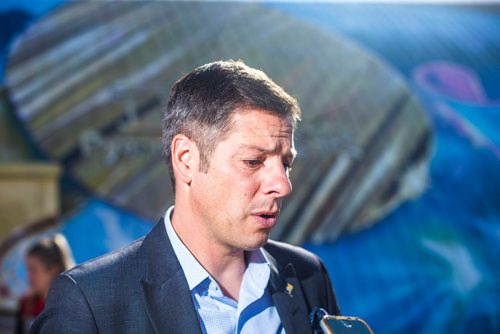 MIKAELA MACKENZIE / WINNIPEG FREE PRESS
Mayor Brian Bowman answers questions from the media about the Investors Group Field financing deal after the unveiling of the St.Vital Curling Club's newest mural in Winnipeg on Friday, July 27, 2018. 
Winnipeg Free Press 2018.